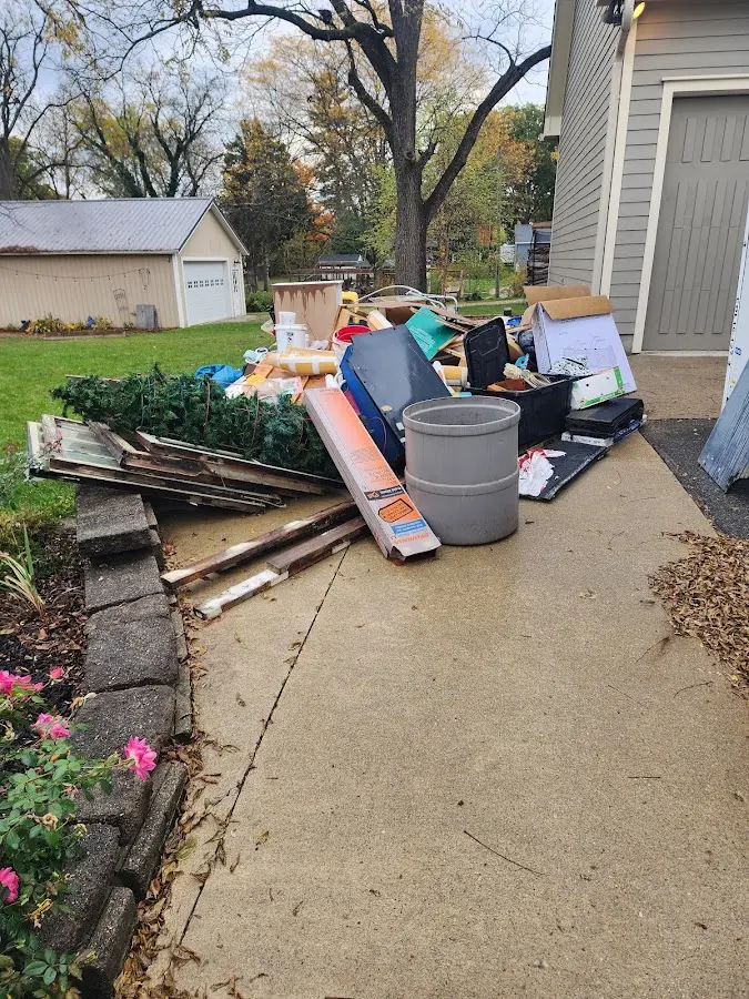 Dumpster being loaded with debris for 12 Yard Dumpster Rental in Casas Adobes